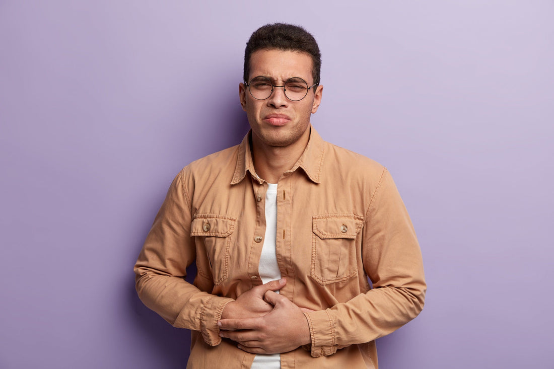Man holding his stomach due to bloating