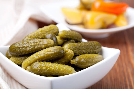 A bowl of pickles rich in electrolytes for hydration and wellness, ready to enhance a nutritious diet.
