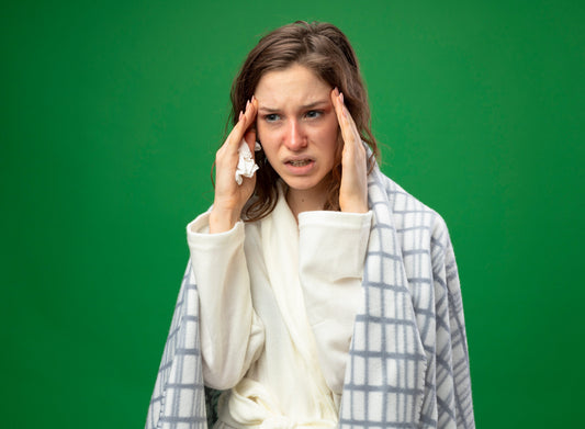 Woman holding her temples with migraine pain.