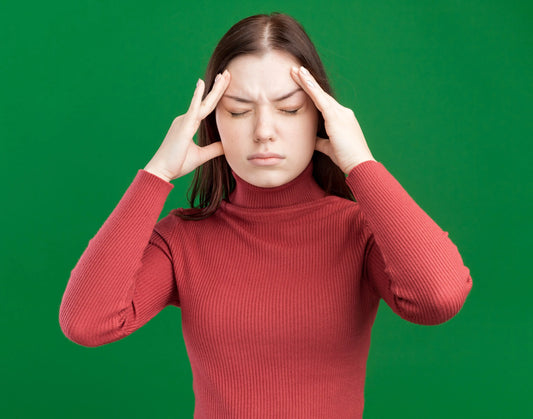 Woman suffering from a migraine attack, showing symptoms associated with a migraine brain vs normal brain.
