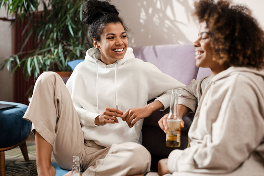 Two young women are smiling, talking, and laughing, illustrating how they feel better now that their POTS symptoms are in remission.