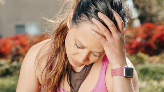 women holding her head because of a headache due to dehydration