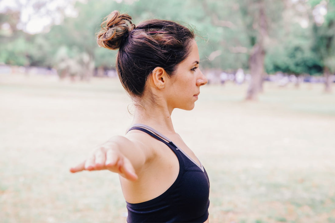 A woman stretches as part of her exercise program to manage her POTS symptoms.