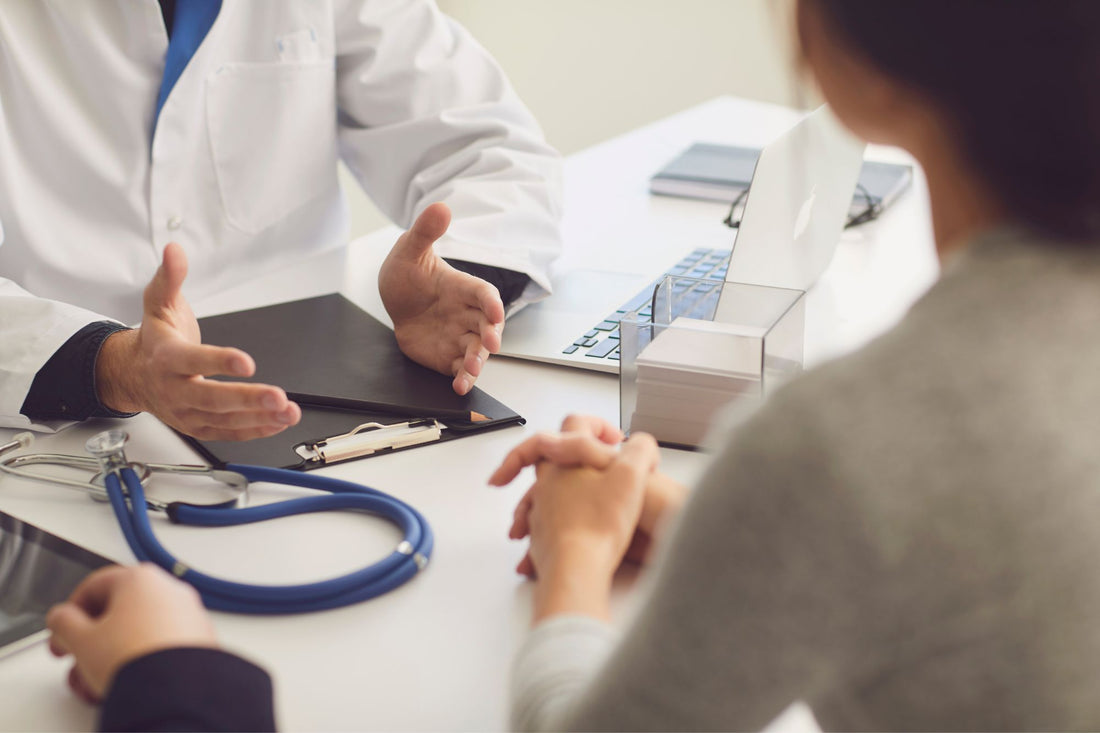 A patient consulting with a doctor, discussing symptoms as part of the POTS diagnosis process.