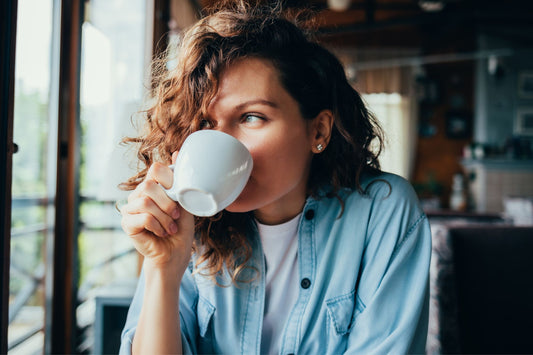 A woman considers her beverage choices while managing hydration with POTS.