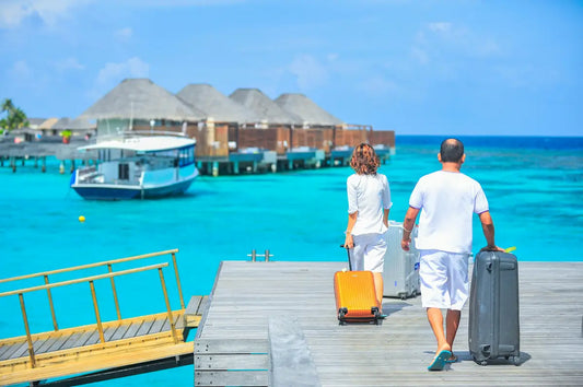 A couple arriving to the hotel in Maldives with their luggage bags
