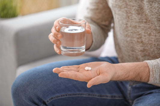 A man prepares to take his POTS medication.