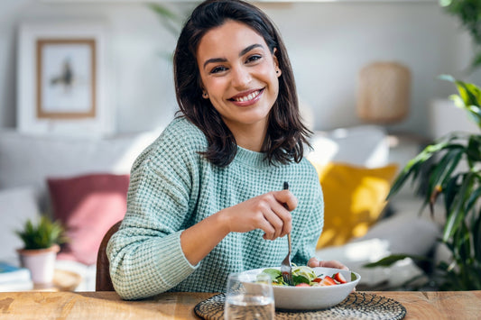 A woman enjoys a POTS-friendly meal to help manage her symptoms.