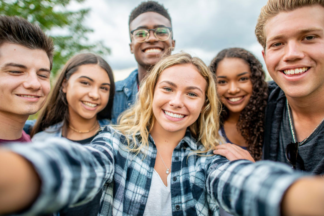 A group of smiling teenagers take a selfie together, symbolizing a POTS support group for teens.