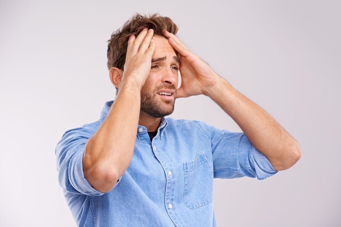 Man experiencing stress migraine symptoms.